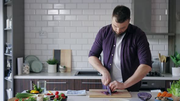Man Cutting Vegetables in the Kitchen alt