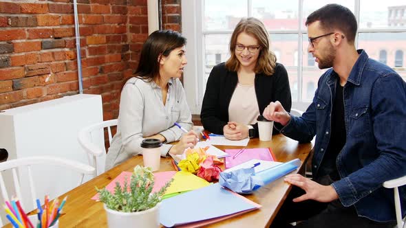 Group of executives having a discussion in the conference room alt