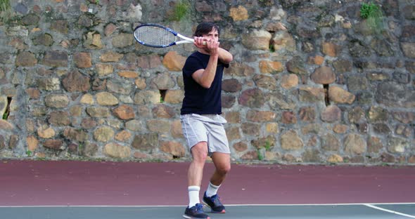 Active man playing tennis alt