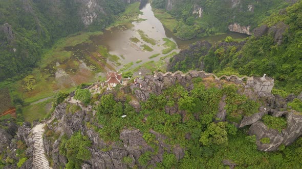 Aerial Shot of the Small Temple and a Dragon on the Top of Marble Mountain Mua Cave Mountain in Ninh alt