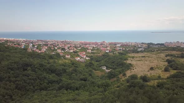 Aerial view of Sunny Beach city that is located on Black Sea shore. Top view of sand beaches with alt