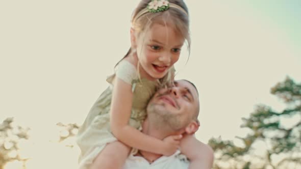Dad Has Fun with His Cute Little Daughter on a Summer Day