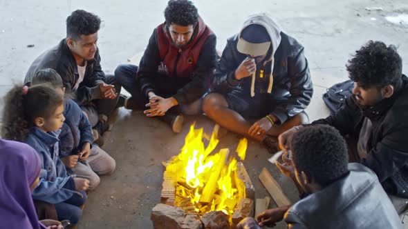 Syrian Refugees Sitting by Fire alt