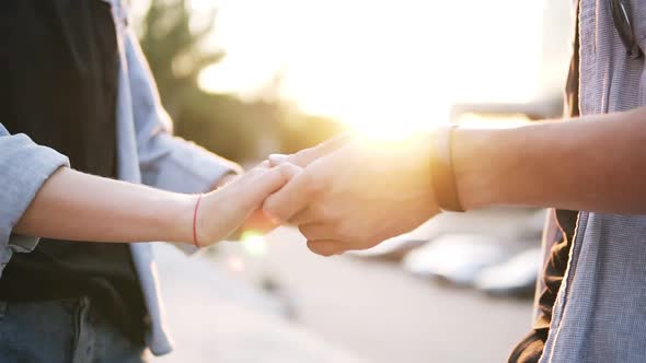 Close Up Footage of Young Couple Holding Hands Having Date in the Park alt