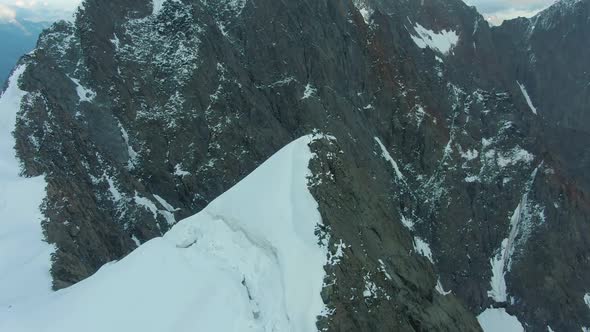 Top of Snow-Capped Mountain in European Alps. Aerial View alt