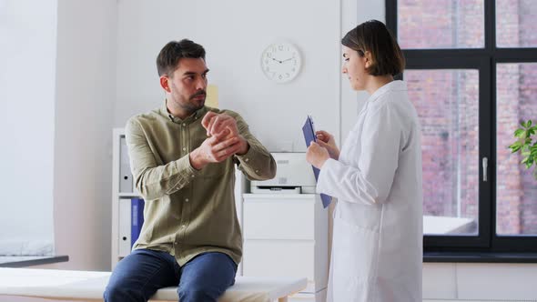 Man Patient Showing Sore Arm to Doctor at Hospital alt