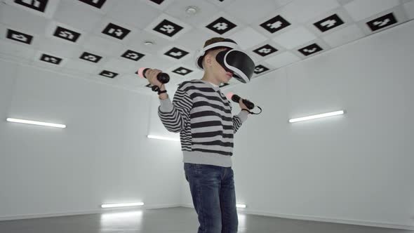 Little Boy in Vr Headset Looking Around in an Empty Room Full of White Neon Light. Tracking Arc Shot