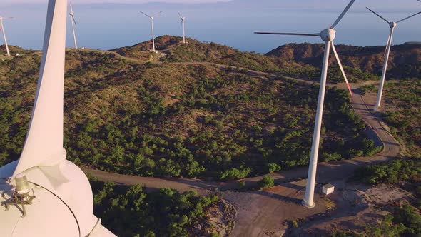 Wind turbines with blades in wind farm aerial view, motion drone alt
