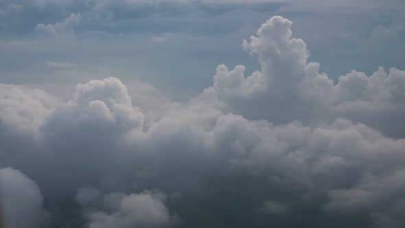 White Soft Fluffy Clouds Over the Green Landscape Aerial View From the Plane alt