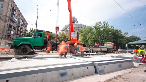 Installing Concrete Plates By Crane at Road Construction Site Timelapse Hyperlapse. alt