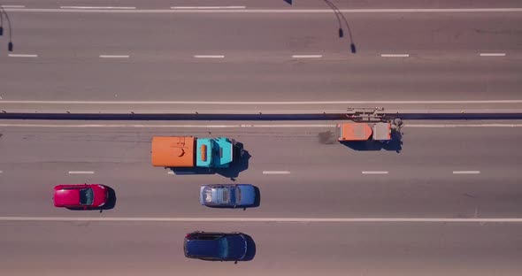 A Specialized Car Cleans the Roadside, Cars Go Around on a Sunny Day