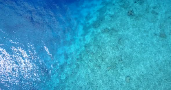 Daytime birds eye travel shot of a sunshine white sandy paradise beach and aqua turquoise water  alt