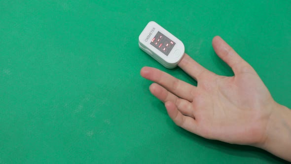 Woman Is Measuring Level of Oxygen Saturation of Blood with a Pulse Oximeter