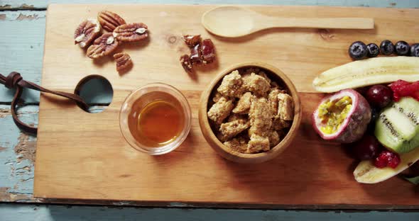 Granola bars in bowl with honey and fruits 4k alt