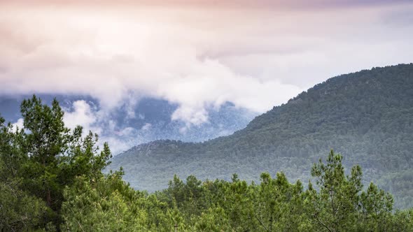 Clouds and mist clearing over a mountainside time lapse