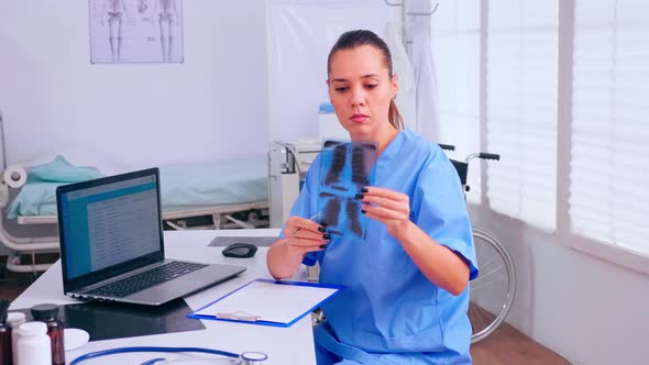 Nurse Checking Xray Result Reading Patients List alt