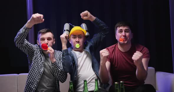 Funny Football Fans Cheering While Watching Televised Match in Room alt