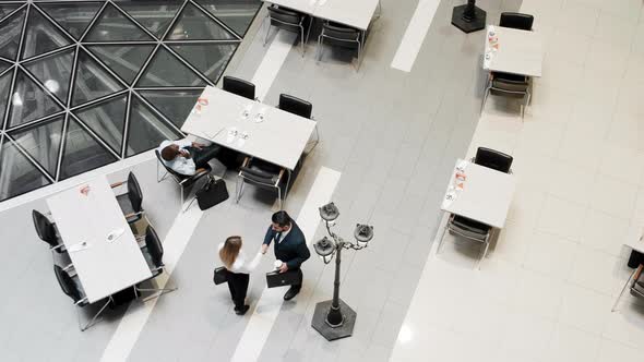 Colleagues shaking hands in buffet