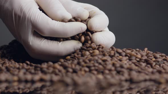 Hands Taking Fistful Coffee Beans Close Up alt