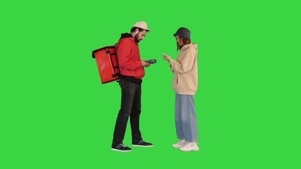 Young Woman Paying with a Phone for Delivery on a Green Screen Chroma Key