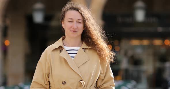 Portrait of a Happy woman in Casual Clothes Standing on the Street Looking at Camera,