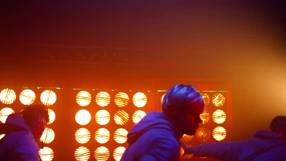 Talented Dancing People Performing Breakdance Moves on Modern Night Club Stage alt