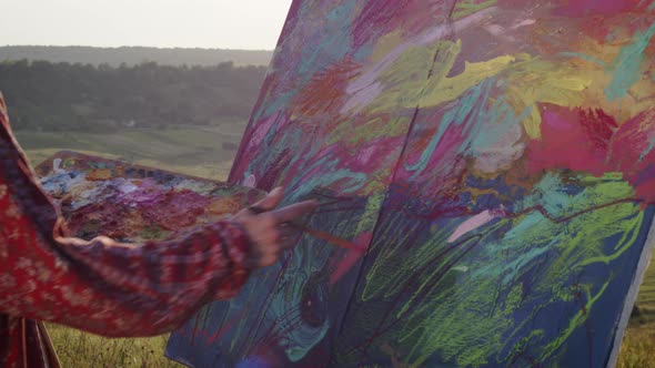 Young Girl Artist Paints Picture In Nature. Outrageous Girl Makes Brush Strokes On The Easel alt