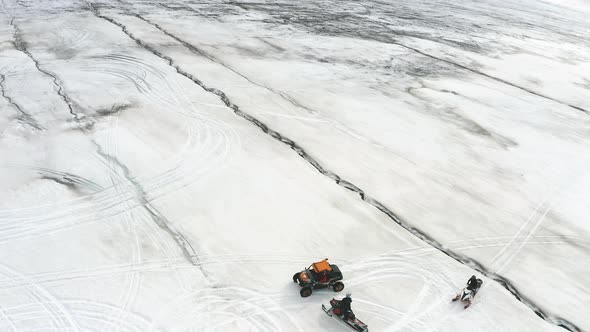 Off-road Vehicle And Snowmobiles On Langjokull Glacier In Iceland. aerial drone descend alt