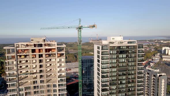 Wide panning aerial of skyscraper construction site in Buenos Aires alt