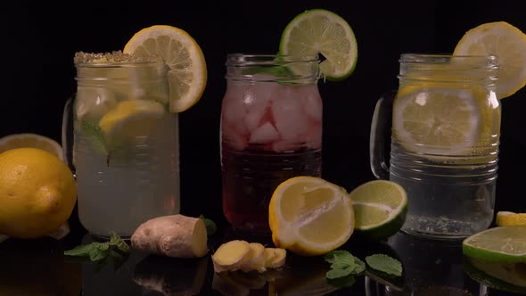 Lemonade Carbonated Water In Jar Rotating With Ginger And Lemon Slices  alt