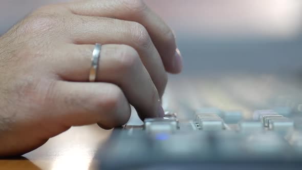 Close-up of a male hand pressing buttons on a switch board for TV production and broadcasting alt