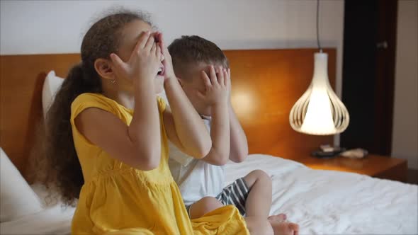 Cute Little Kids While Watching TV on Laptop. Boy and Girl Watch Cartoon on Laptop on Living Room alt
