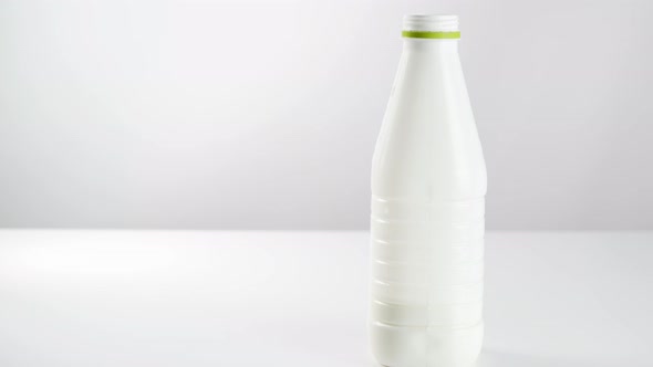 Dairy Product In A Plastic Bottle On A White Background, Yogurt In A Glass Beaker. Kefir. Milk alt