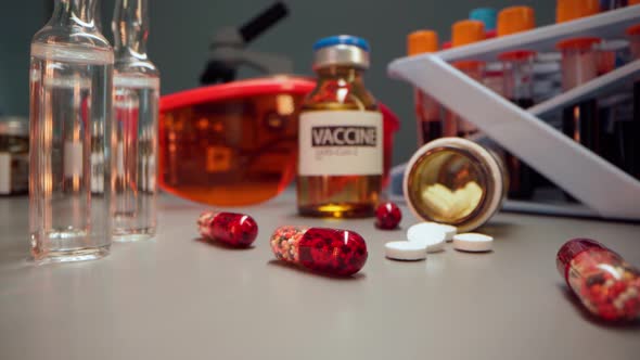 Zoom in Macro Shot of Coronavirus Vaccine Bottle and Ampoules