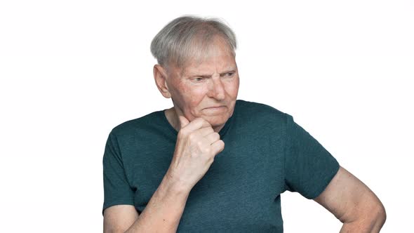 Portrait of Concentrated Old Aged Man 80s Having Gray Hair in Basic Tshirt Touching His Chin and alt