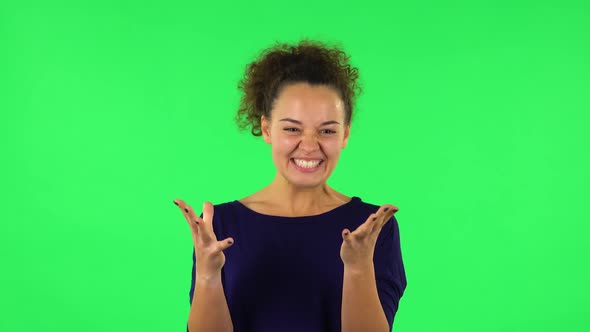 Portrait of Curly Woman Indignantly Talking To Someone, Looking at the Camera. Green Screen alt