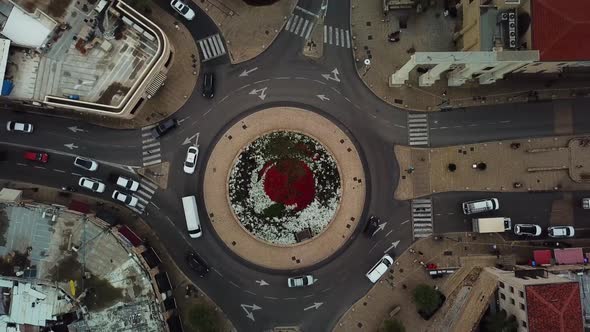 Aerial clip of traffic slowly moving along Yossi Carmel Square roundabout in Jaffa Israel alt
