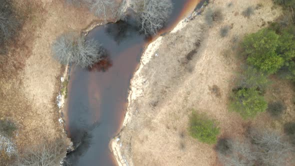AERIAL: Flying Above Shallow Dark Water River in Eastern Europe