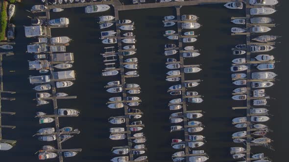 Top Down Slow Aerial Pan of Docked Boats at a Marina in Port Washington alt