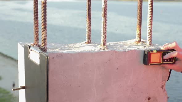 Building Engineer does Measurements of the Building alt