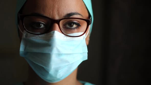 Young female medic, wearing a mask and glasses