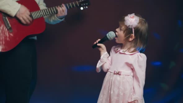 Llittle Girl in Vintage Dress Sings on Stage Her Father Plays Acoustic Guitar alt