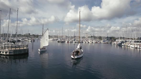 Two Old Classic Sailboats Pass Each Other On The Way To Port