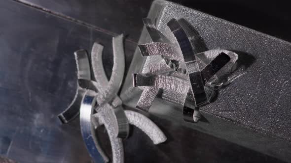 Close Up at the Edges of Processed and Polished Silver Bar and Metal Shavings at the Factory alt