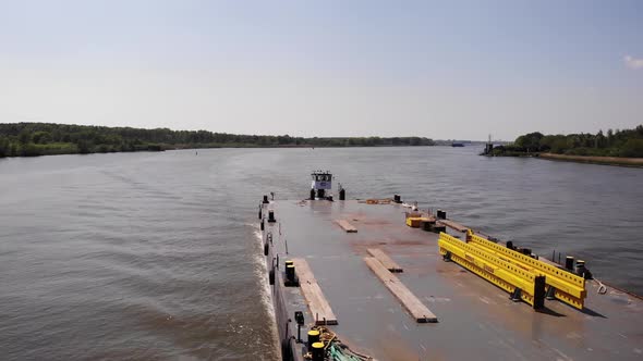 Pontoon Boat Sailing Across The River In Netherlands At Daytime. close up, aerial alt