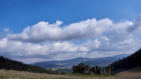 Clouds moving with ana blue sky during the day alt
