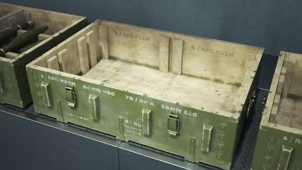 Robot packing military boxes with RPG missiles. Packing line. Warehouse. 4KHD alt