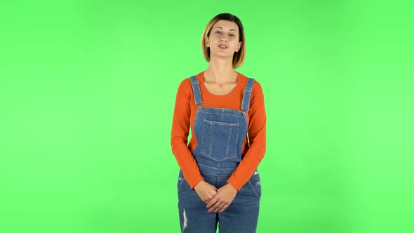 Beautiful Girl Is Reporting and Tells a Lot of Interesting Informations. Green Screen alt