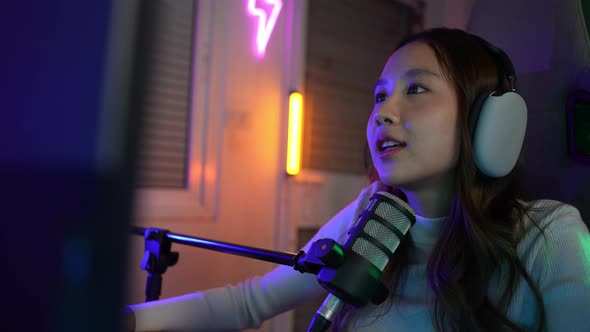 Gamer and E-Sport online of Asian woman playing online computer video game with lighting effect alt