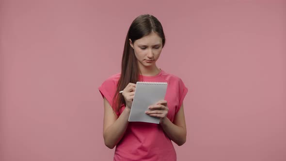 Portrait of Fashion Model is Thinking and Writing Down Her Ideas in Notebook alt